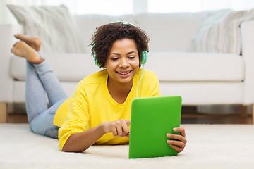 Image showing happy african woman with tablet pc and headphones