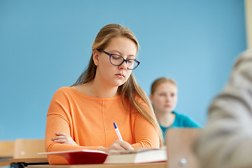 Image showing group of students with books writing school test