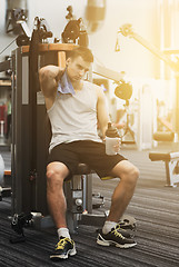 Image showing man exercising on gym machine