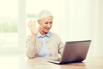 Image showing senior woman with laptop having video chat at home