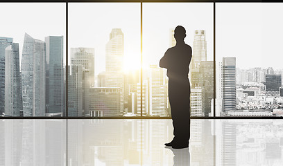 Image showing silhouette of business man over office background