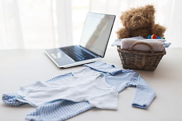 Image showing close up of baby clothes and toys for newborn