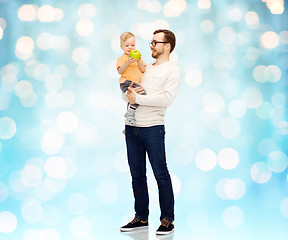 Image showing happy father and little son with green apple