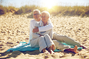 Image showing happy senior couple hugging on summer beach