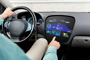 Image showing close up of man driving car with gps navigator map