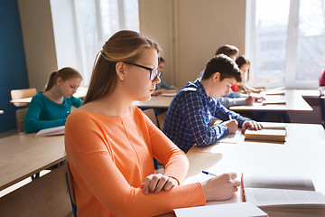 Image showing group of students with books writing school test