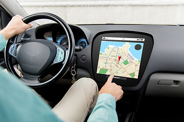 Image showing close up of man driving car with gps navigator map