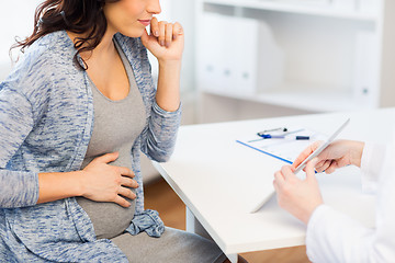 Image showing close up of doctor with tablet and pregnant woman