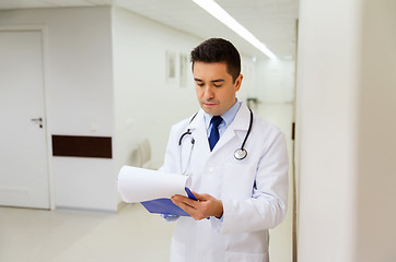 Image showing doctor writing to clipboard at hospital