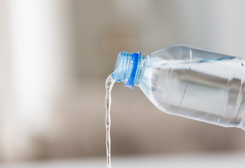 Image showing close up of water pouring from plastic bottle