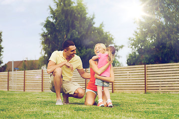 Image showing happy family hugging outdoors