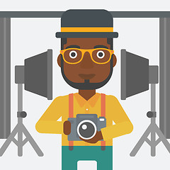 Image showing Smiling photographer holding camera.