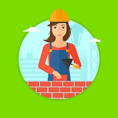 Image showing Bricklayer with spatula and brick.