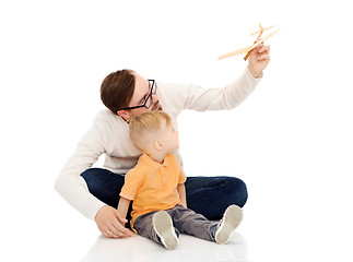 Image showing father and little son playing with toy airplane