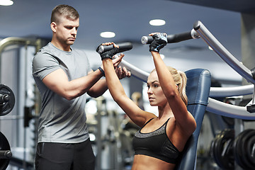 Image showing man and woman flexing muscles on gym machine