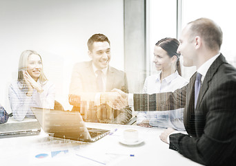 Image showing two businessman shaking hands in office