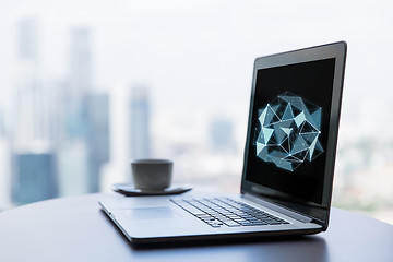 Image showing close up of laptop and coffee cup on office table