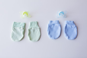 Image showing close up of baby mittens and soothers for twins