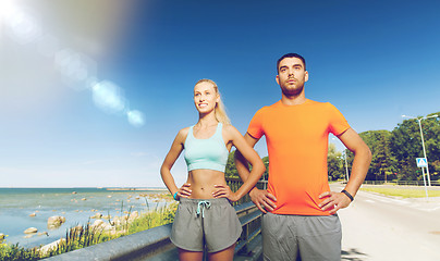 Image showing happy couple exercising at summer seaside