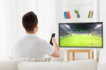 Image showing man watching football or soccer game on tv at home