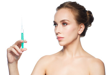 Image showing beautiful woman holding syringe with injection