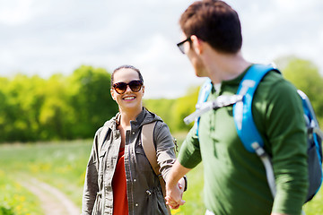 Image showing happy couple with backpacks hiking outdoors