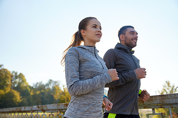 Image showing happy couple running outdoors