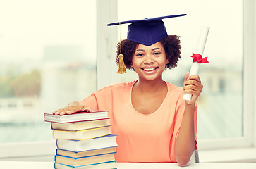 Image showing happy african bachelor girl with books and diploma