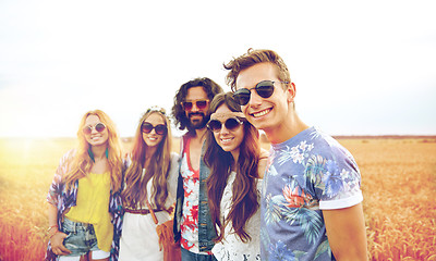 Image showing smiling young hippie friends on cereal field