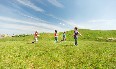 Image showing group of happy kids running outdoors