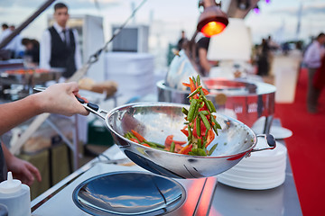 Image showing chef tossing vegetables in a wok