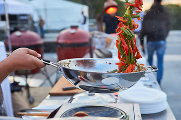 Image showing chef tossing vegetables in a wok