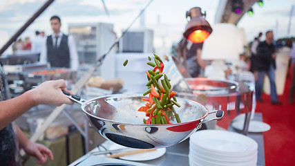 Image showing chef tossing vegetables in a wok