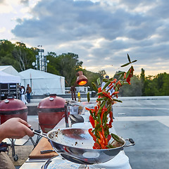 Image showing chef tossing vegetables in a wok