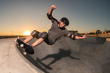 Image showing Skateboarder in a concrete pool 