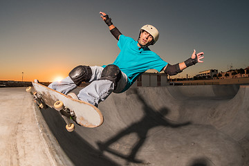 Image showing Skateboarder in a concrete pool 