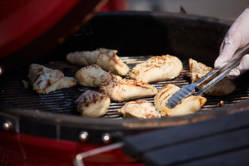 Image showing thick strip steak being grilled outdoors. Shallow dof