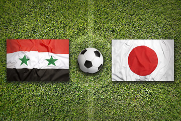 Image showing Iraq vs. Japan flags on soccer field