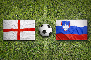 Image showing England vs. Slovenia flags on soccer field