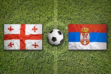 Image showing Georgia vs. Serbia flags on soccer field