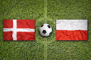 Image showing Denmark vs. Poland flags on soccer field