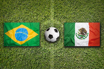 Image showing Brazil vs. Mexico flags on soccer field