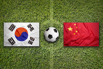 Image showing South Korea vs. China flags on soccer field