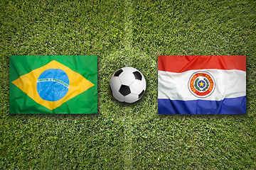 Image showing Brazil vs. Paraguay flags on soccer field