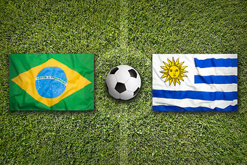 Image showing Brazil vs. Uruguay flags on soccer field