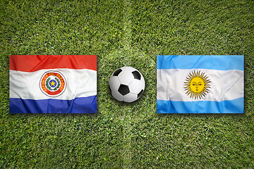 Image showing Paraguay vs. Argentina flags on soccer field
