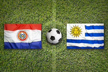 Image showing Paraguay vs. Uruguay flags on soccer field