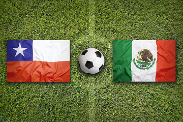 Image showing Chile vs. Mexico flags on soccer field
