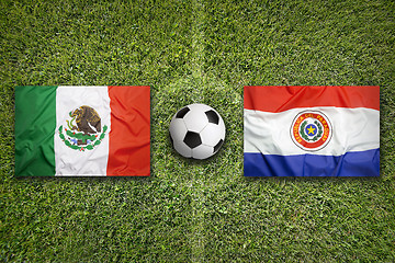 Image showing Mexico vs. Paraguay flags on soccer field