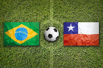 Image showing Brazil vs. Chile flags on soccer field